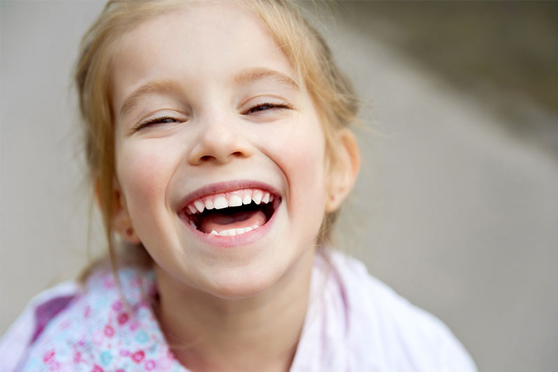 Little girl who does not have Ear, Nose, or Throat infection laughing