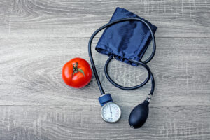 Tomato next to a stethoscope symbolizing diet's role in heart health