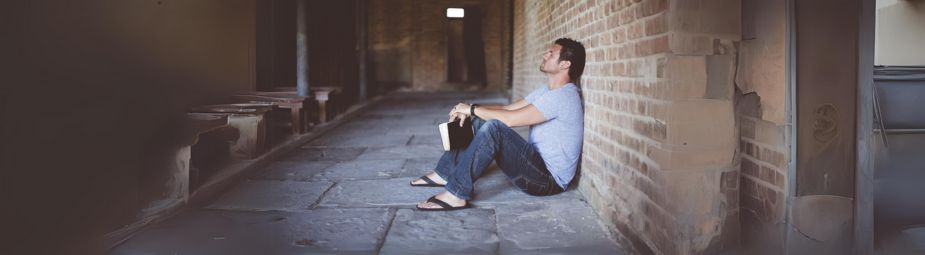 A person holding their head in distress, symbolizing opioid withdrawal symptoms and the need for effective treatment options.