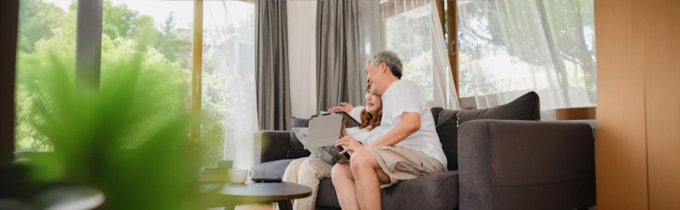 Doctor performing a bone marrow aspiration procedure on a patient’s pelvic bone using a thin needle.