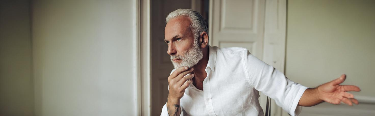 Close-up of a dermatologist applying a chemical peel to treat actinic keratosis on a patient's skin.