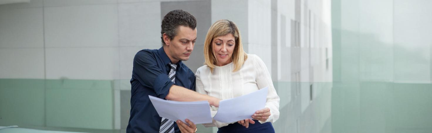 A forensic psychologist conducting a mental health evaluation for a legal case, reviewing documents and taking notes.