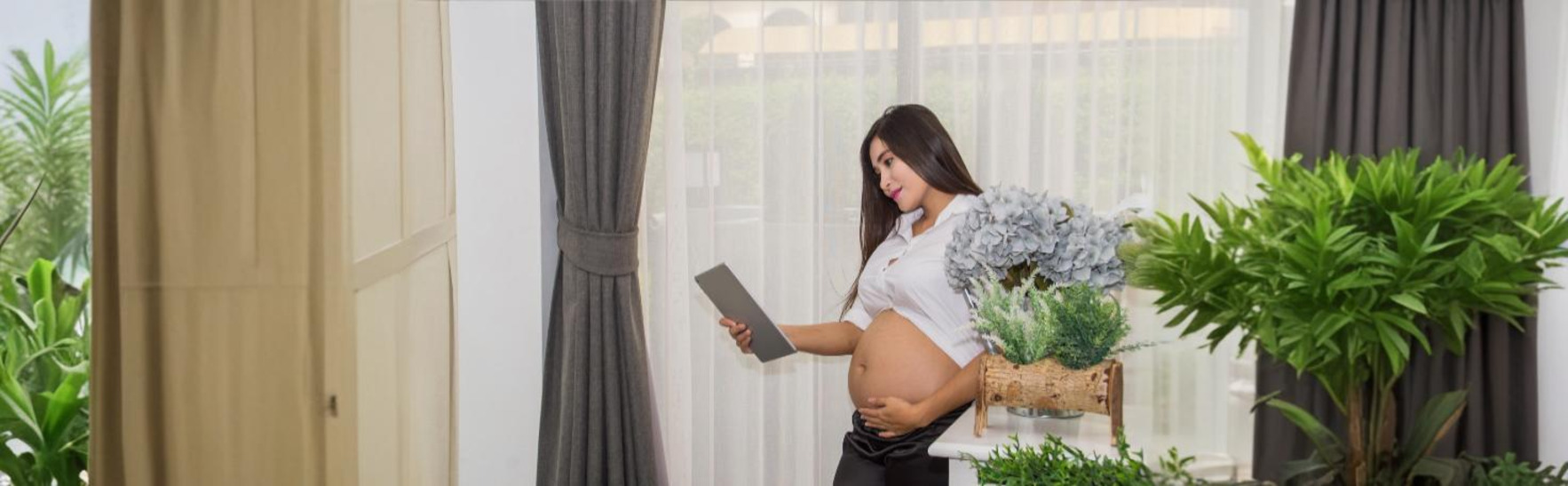 Doctor using a fetal heart rate monitor to check a baby's heartbeat during pregnancy.
