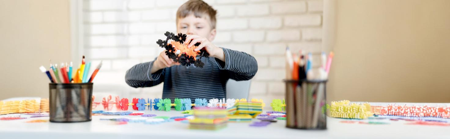 A behavioral health professional conducting a Functional Behavioral Assessment (FBA) with a child to analyze behavioral patterns.