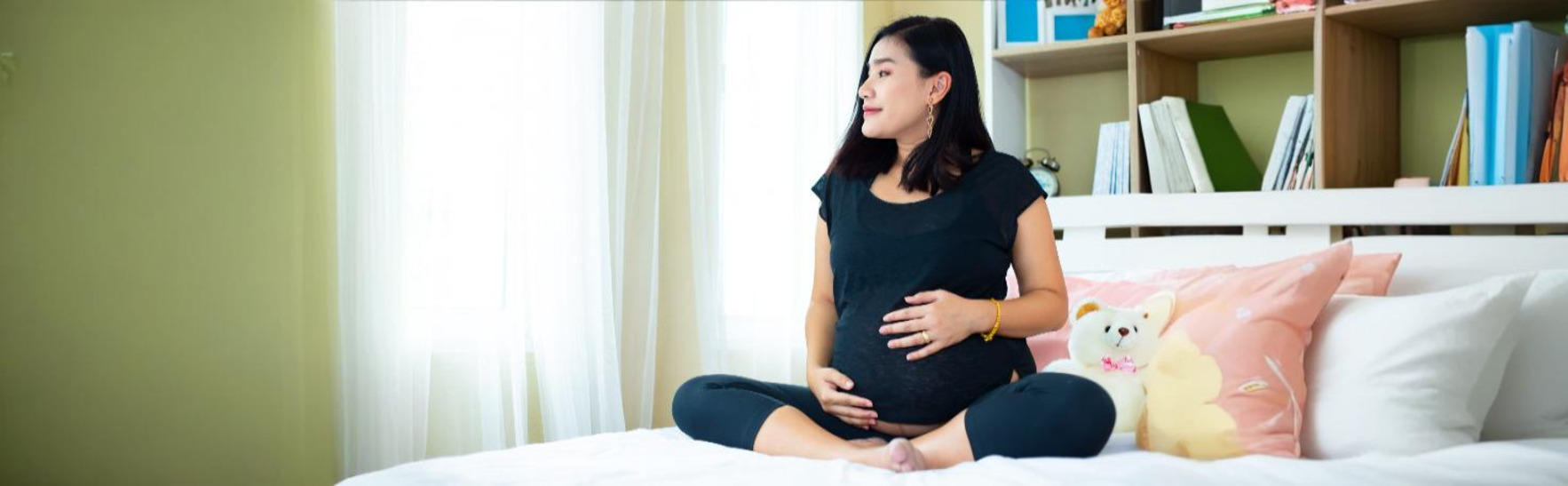Close-up of a Nitrazine pH test strip changing color to detect amniotic fluid leakage during pregnancy.