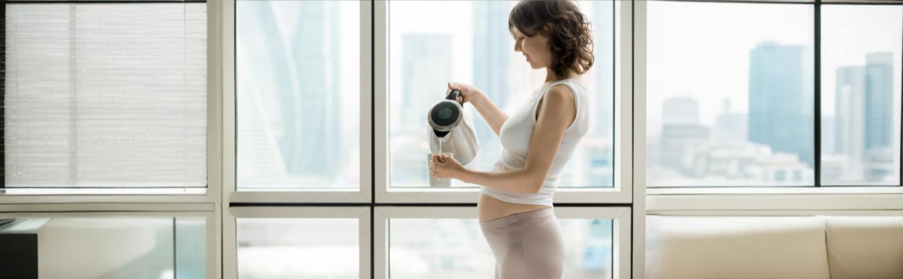 Doctor performing a nuchal translucency scan on a pregnant woman to assess fetal health.