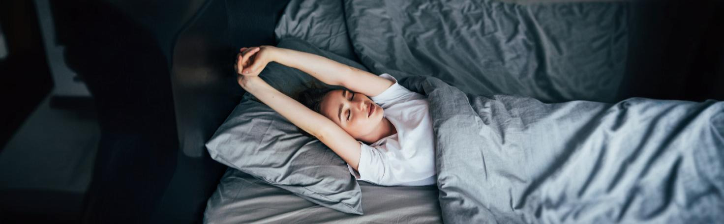 A person filling out the Pittsburgh Sleep Quality Index questionnaire to assess sleep health.
