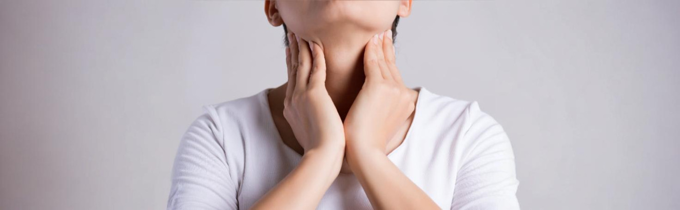 Doctor performing a thyroid ultrasound scan on a patient's neck to assess thyroid health.