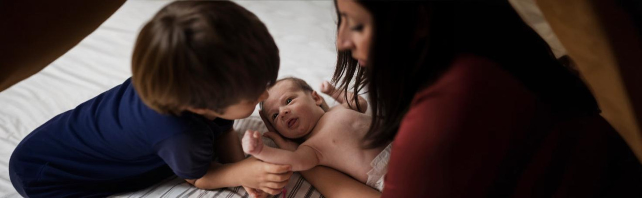 Close-up of an eye undergoing a pupillary light reflex test with a medical professional shining a light to assess pupil response.
